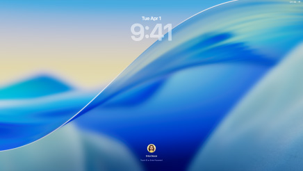 Three Mac models facing forward, 16-inch MacBook Pro in Silver at left with Phone app on screen showing recent contacts, 24-inch iMac in Blue in center macOS Tahoe wallpaper on screen, and 13-inch MacBook Air in Midnight at right, screen shows Spotlight Search over the desktop with Liquid Glass versions of the Dock and various widgets such as Calendar, Clock, and Weather